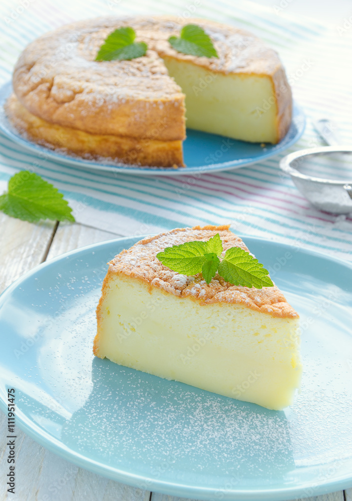 Japanese cheesecake decorated with mint, icing sugar and strawberry