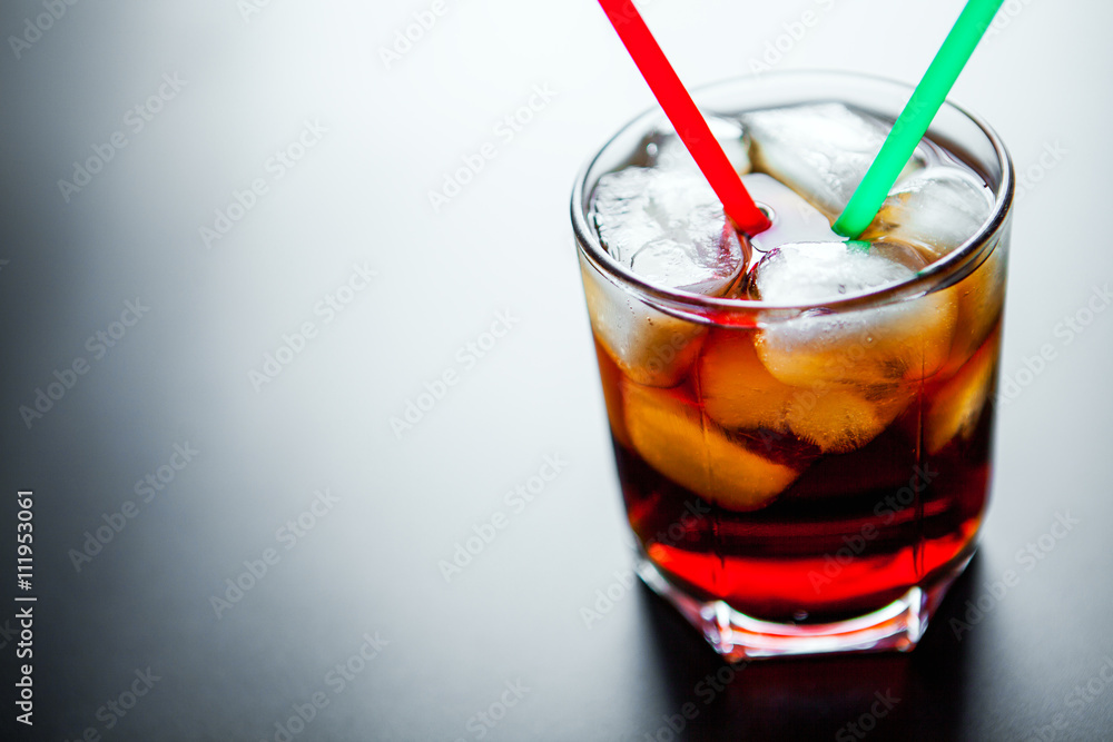soft drinks. Cola glass with ice cubes on a white background