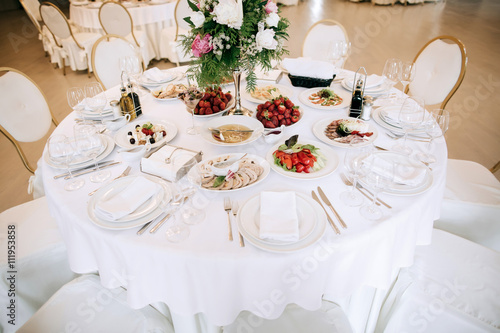 Restaurant table with food. Catering service.  Wedding celebration, decoration. Dinner time, lunch. © Yevhenii Kukulka