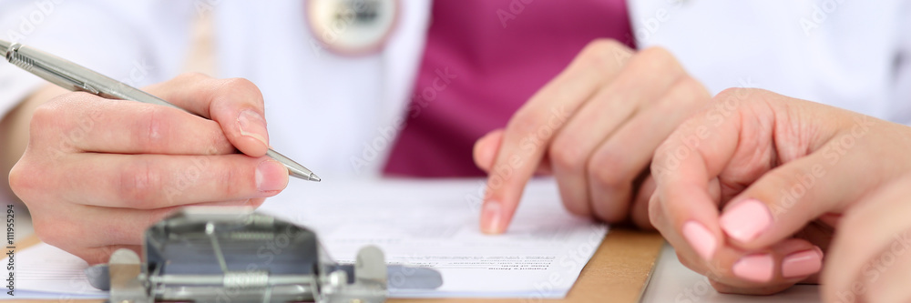 Female doctor hand hold silver pen Female doctor hand hold silver pen