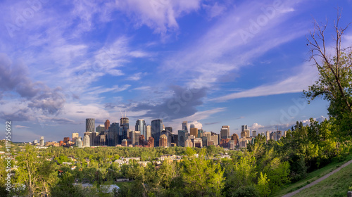 View of the Calgary skyline in the evening with parkland in the foreground.