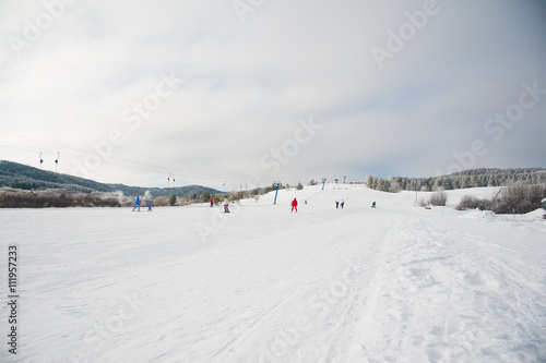 People skiing and snowboarding on a slope