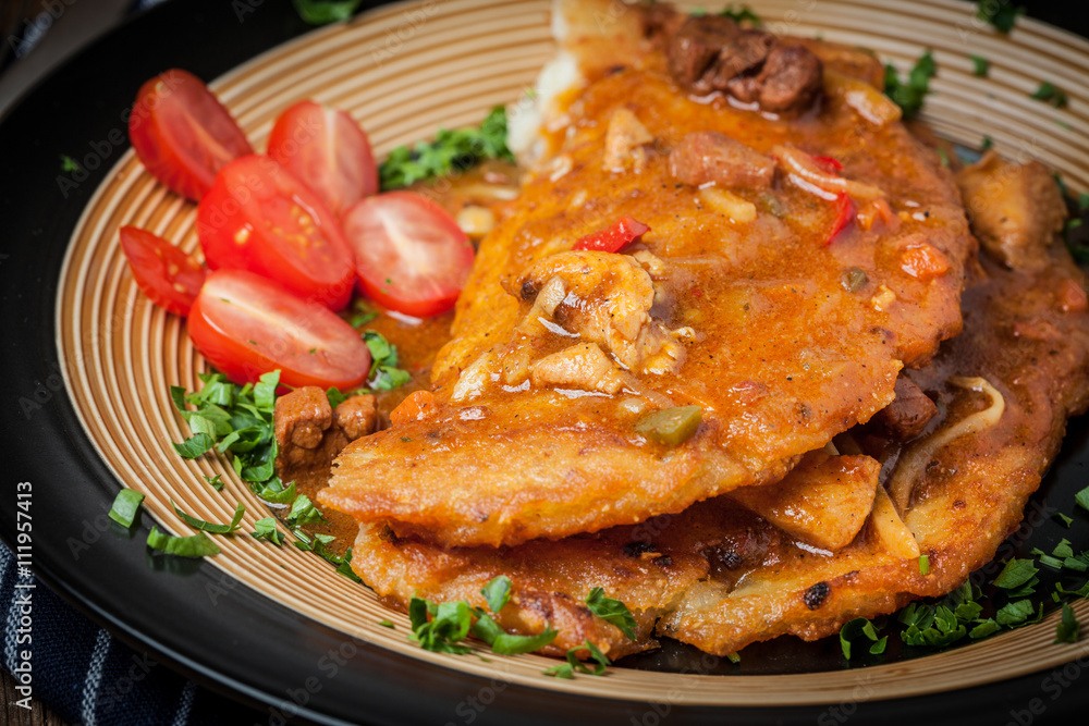Potato pancakes with meat stew served on a plate. Potato pancakes with meat stew served on a plate.