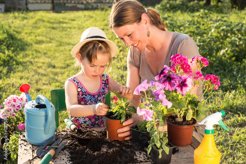 mother and daughter planting flowers