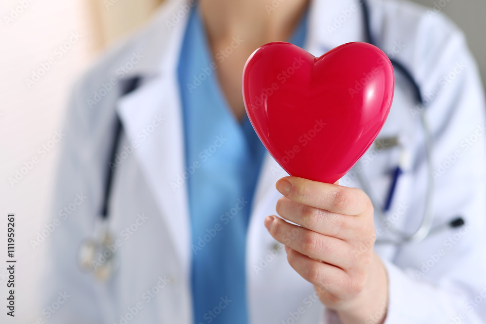 Female medicine doctor hands holding red heart Female medicine doctor hands holding red heart