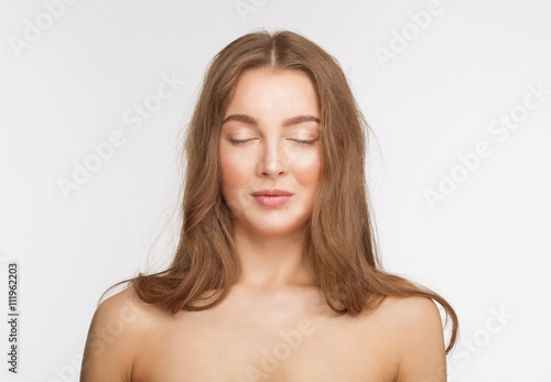 Portrait of happy smiling beautiful shirtless lady with her eyes closed over white background in studio. Fashion or vogue concept.