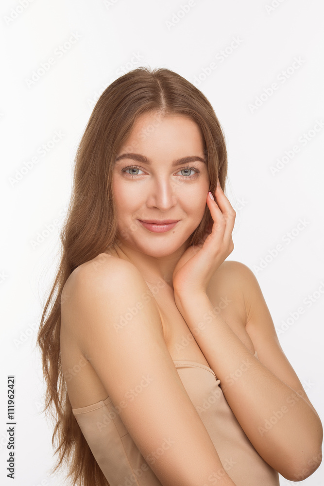 Portrait of smiling lady posing for photographer in studio. Happy beautiful shirtless lady touching her face with left hand over white background. Portrait of smiling lady posing for photographer in studio. Happy beautiful shirtless lady touching her face with left hand over white background.
