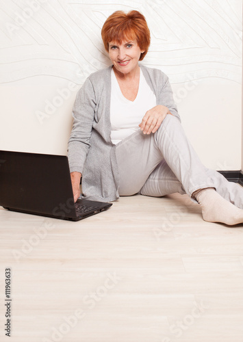 Woman sitting on floor with laptop