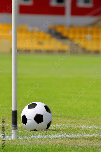 Soccer ball on football green field on the corner © wideonet