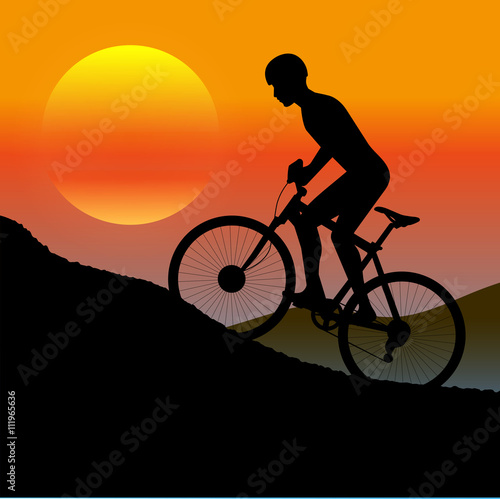 Fototapeta Naklejka Na Ścianę i Meble -  cycle races in mountains silhouette at sunset a sun