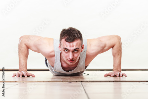 Sports man making pushups,