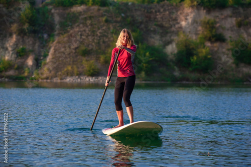 SUP Stand up paddle board woman paddle boarding11 © serguastock