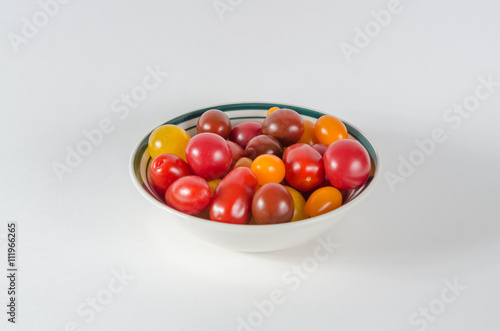 Close up from above of wild gourmet tomatoes on white background
