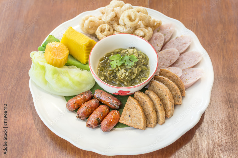 Hors d'oeuvres food Northern style tradition Thai cuisine menu with herbs fried sausage, pork, boiled cabbage, boiled pumpkin, sour pork, chili youth delicious food in Chiang mai province Thailand. Hors d'oeuvres food Northern style tradition Thai cuisine menu with herbs fried sausage, pork, boiled cabbage, boiled pumpkin, sour pork, chili youth delicious food in Chiang mai province Thailand.