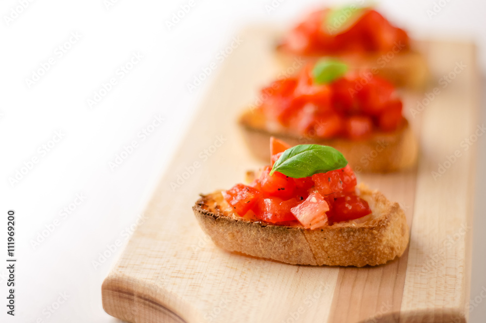 Bruschetta is an italian food made of chopped tomatoes, garlic, basil and fresh herbs on a toasted bread. These are traditionally served as snacks or antipasti (appetizers).