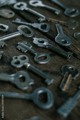 Set of keys on wood background. tight focus with blur background