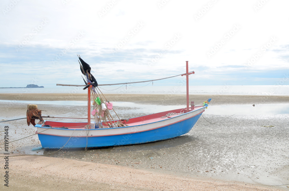 Naklejka premium boat at the beach at sunrise in pranburi, Prachuap Khiri Khan, thailand