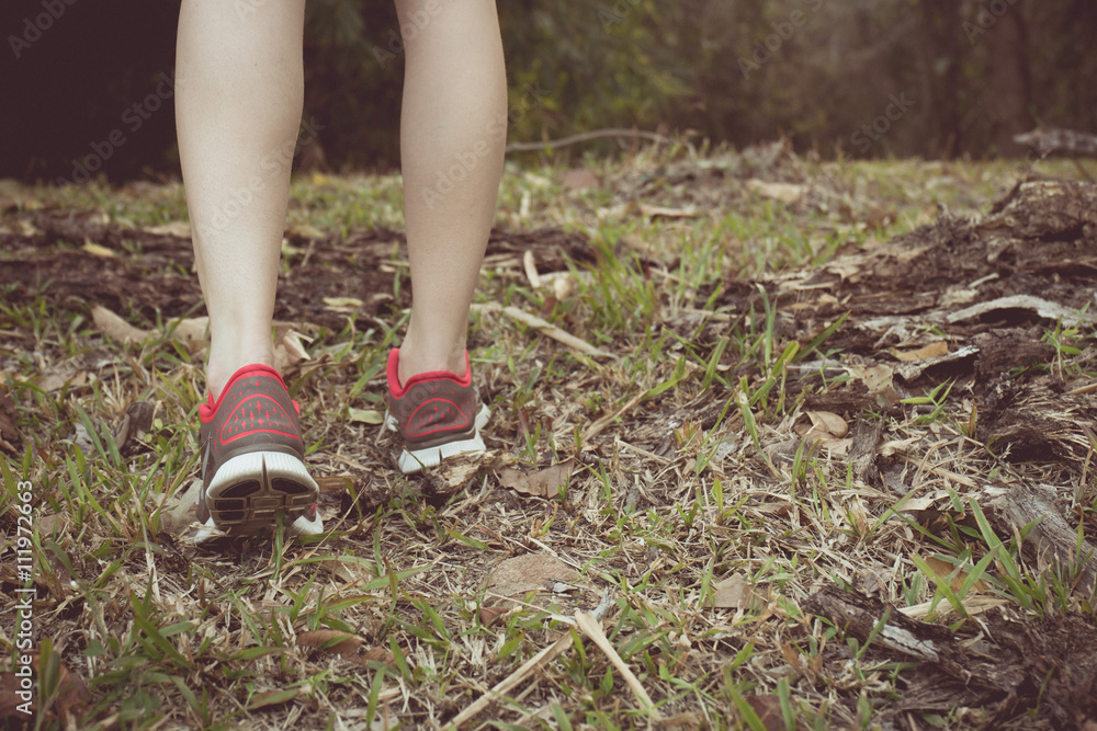 Vintage tone of Walking or running legs in forest, adventure and