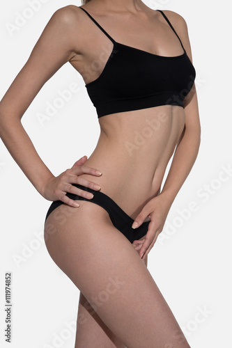 Fitness woman body in black isolated on white