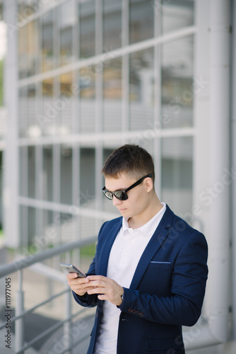 Portrait of a young businessman with smartphone © BooblGum