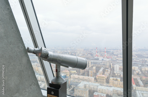 Binoculars on a viewing platform on the top floor of a skyscraper © IgorTravkin