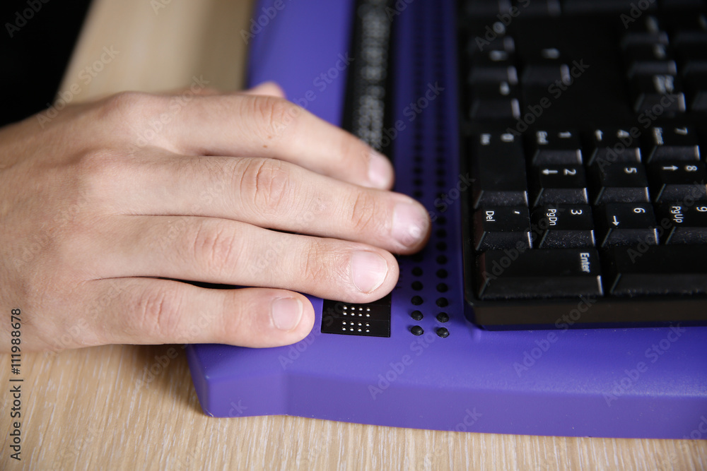 Blind person using computer with braille computer display