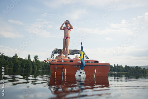 Girl stsnding on a small boat
