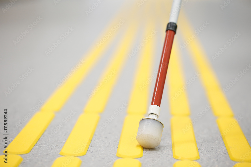 Blind pedestrian walking on tactile paving