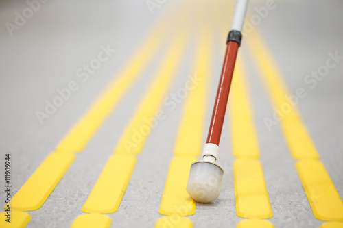 Blind pedestrian walking on tactile paving