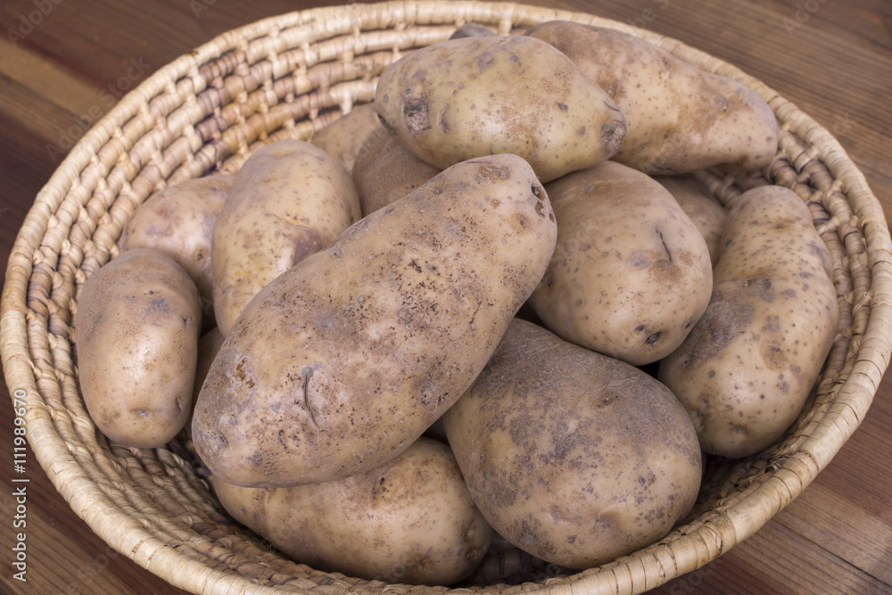 Russet potatoes in woven basket Russet potatoes in woven basket