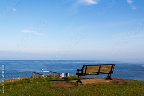  Empty bench over looking the coast in Bude, Cornwall