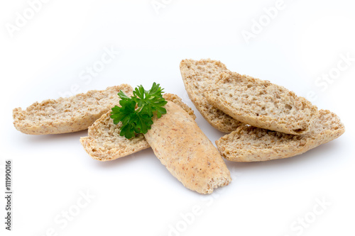 Dry flat bread crisps with herbs on a white background.