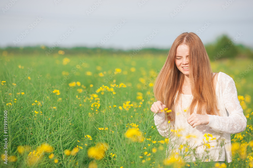 Pollen allergy, girl sneezing in a field of flowers. Pollen allergy, girl sneezing in a field of flowers.