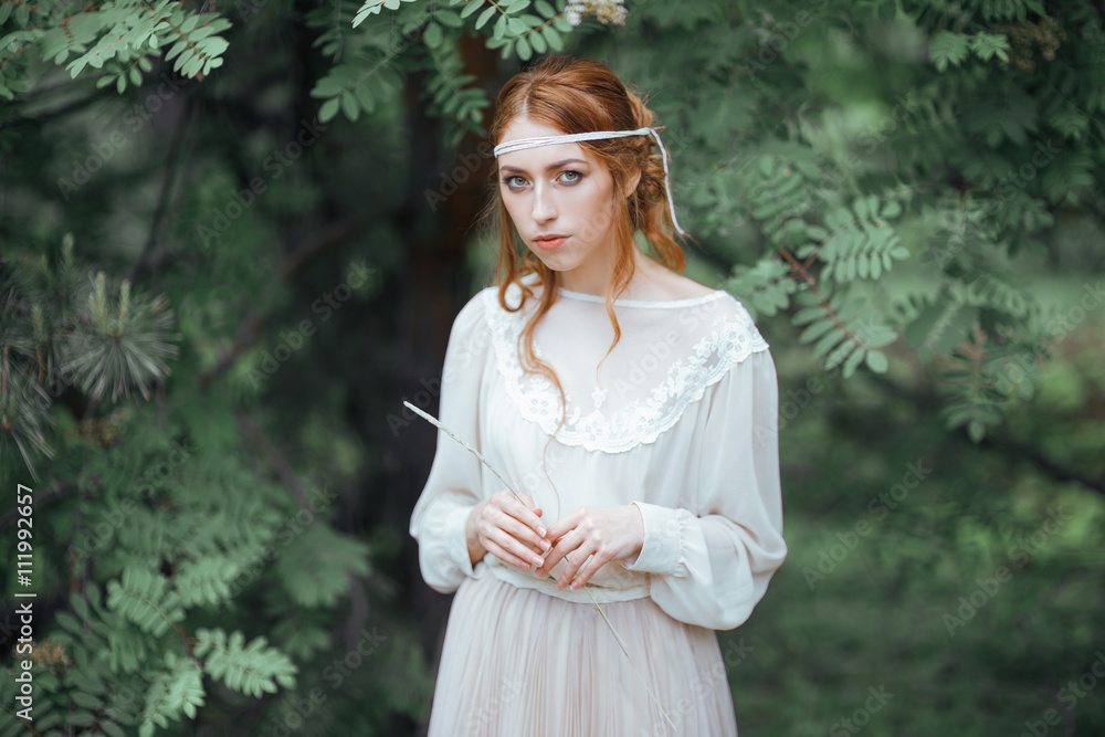 Obraz premium Beautiful artistic photo portrait of a mysterious girl in white dress in the woods