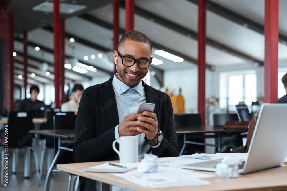 Businessman is texting on smartphone