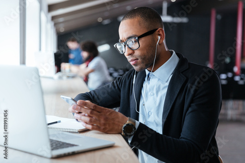 Concentrated young businessman received bad news on the the smartphone