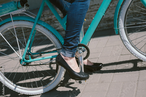 Female feet in shoes on the bike