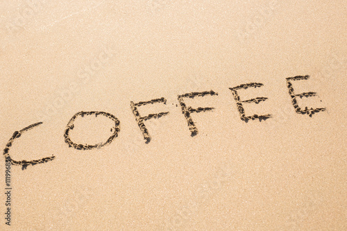 coffee drawn on sand beach