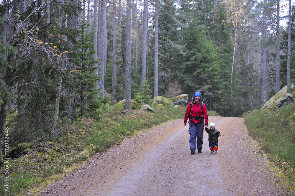 Mother with child walking through forest, Tiveden, Sweden Mother with child walking through forest, Tiveden, Sweden