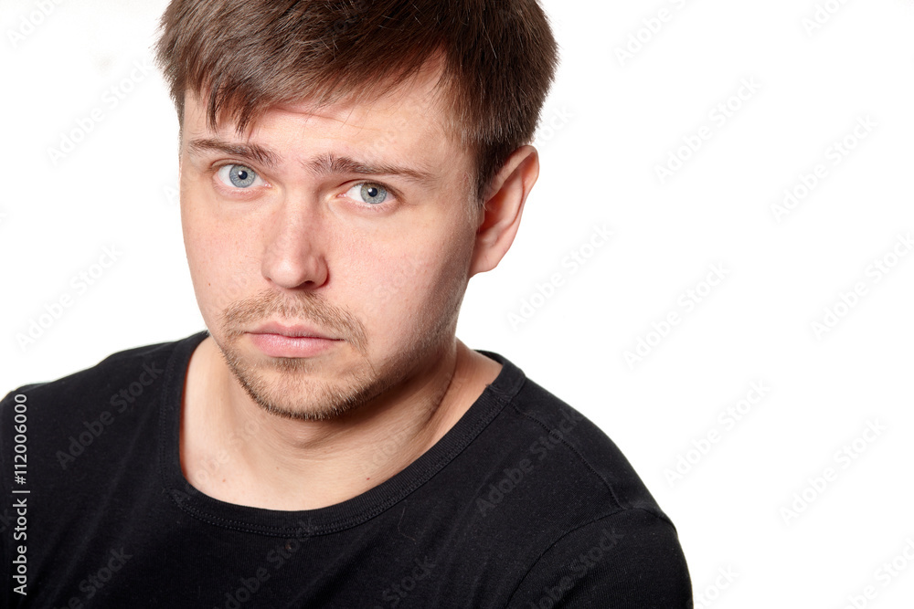 Portrait of serious young man, questioning expression,horizontal, on white Portrait of serious young man, questioning expression,horizontal, on white