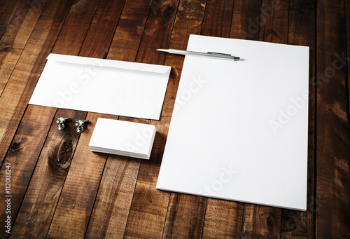 Blank business brand template on wooden table background. Blank stationery set. Corporate identity template. Letterhead, business cards, envelope and pen.