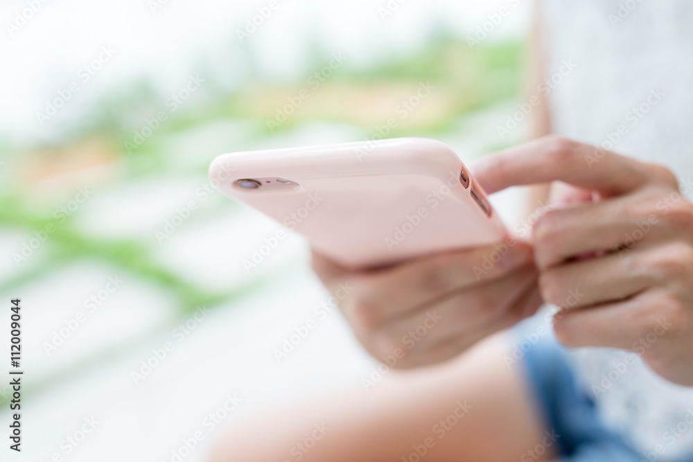 Woman sending sms on cell phone