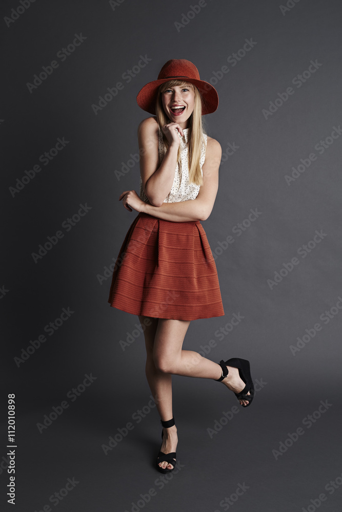Posing young model in gray studio, smiling Posing young model in gray studio, smiling