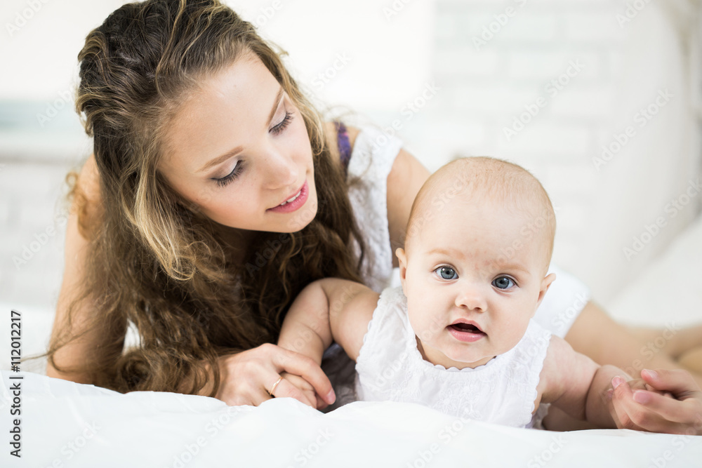 happy family. mother playing with her baby in the bedroom. happy family. mother playing with her baby in the bedroom.