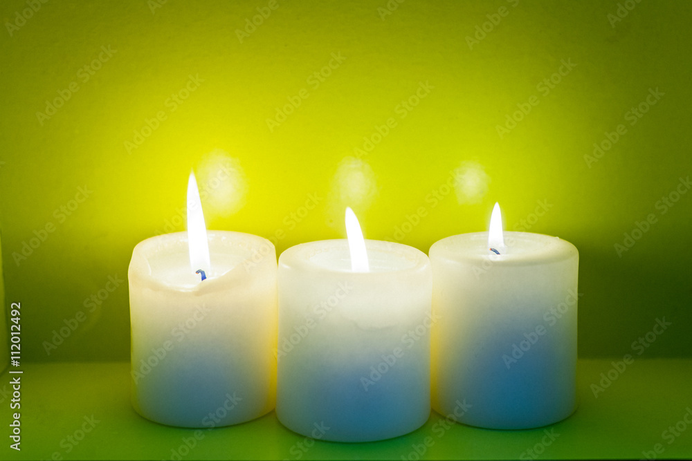 Colorful scented candles on a dark green background Colorful scented candles on a dark green background