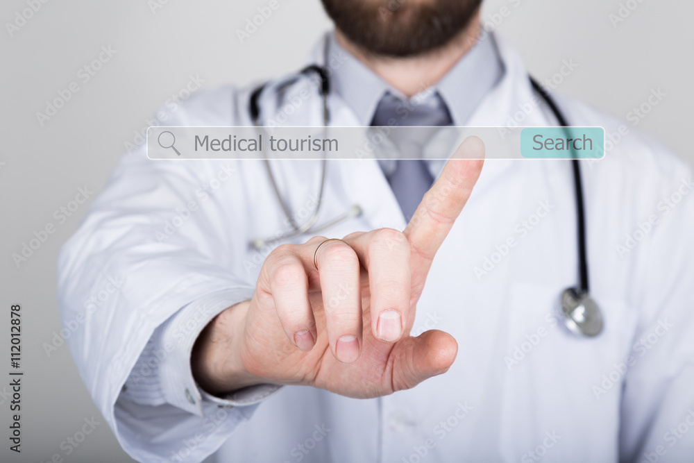 technology, internet and networking in medicine and tourism concept - medical doctor presses button on virtual screens. medical tourism written in search bar on virtual screen technology, internet and networking in medicine and tourism concept - medical doctor presses button on virtual screens. medical tourism written in search bar on virtual screen