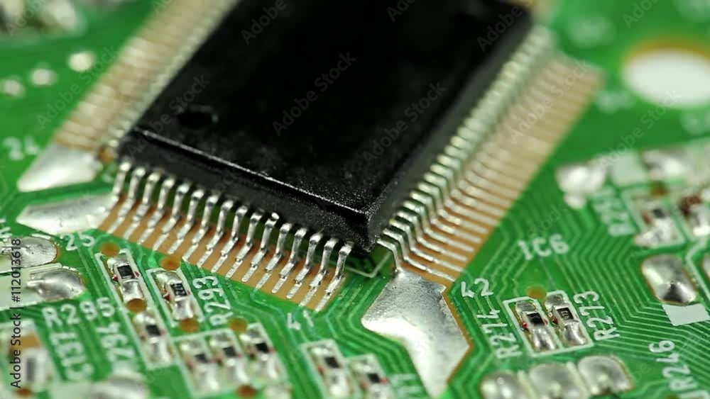 Green microcircuit chip with electronic components. Close-up of micro circuit, resistors and chips. Chips and resistors on green circuit board close up.Close up of electronic circuit board, macro lens Green microcircuit chip with electronic components. Close-up of micro circuit, resistors and chips. Chips and resistors on green circuit board close up.Close up of electronic circuit board, macro lens