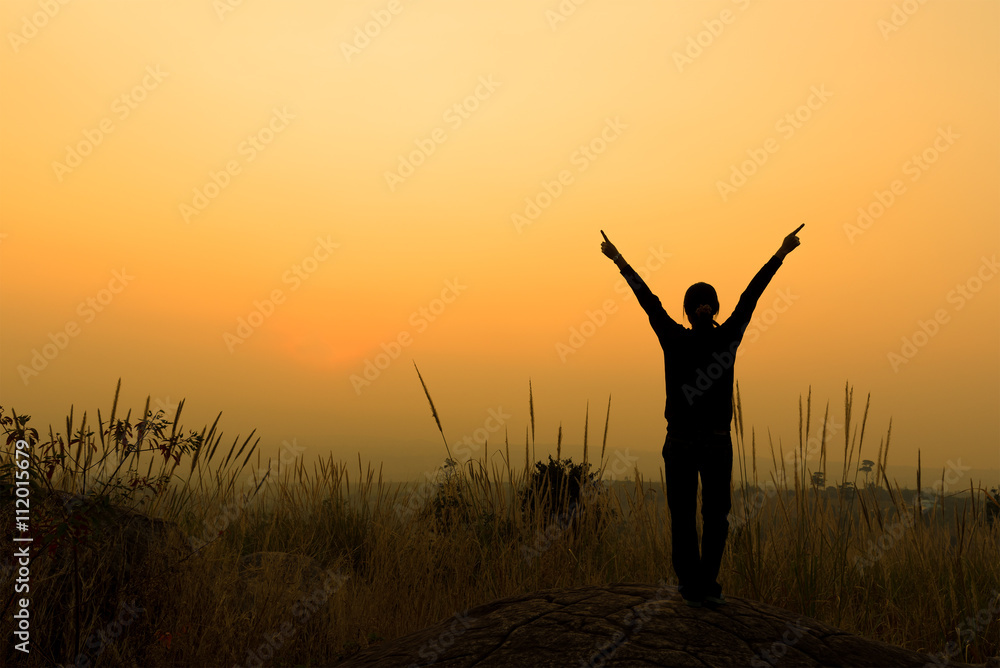 Silhouette of woman spreading hand to the sky Silhouette of woman spreading hand to the sky