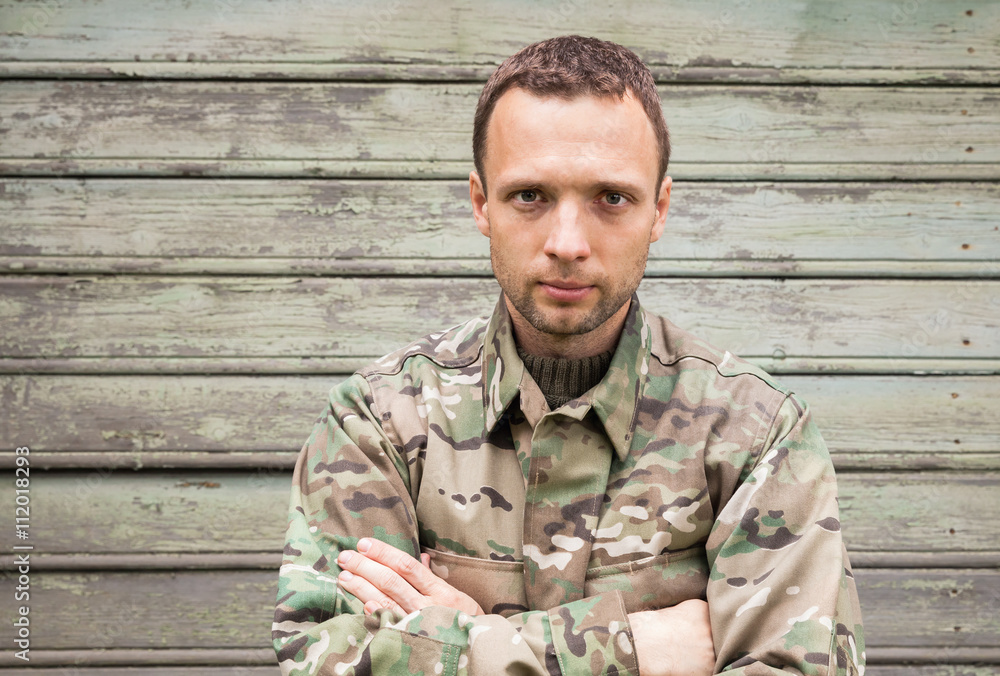 Young handsome Caucasian man in camouflage