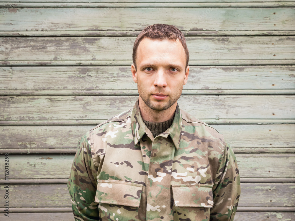 Young man in military camouflage uniform